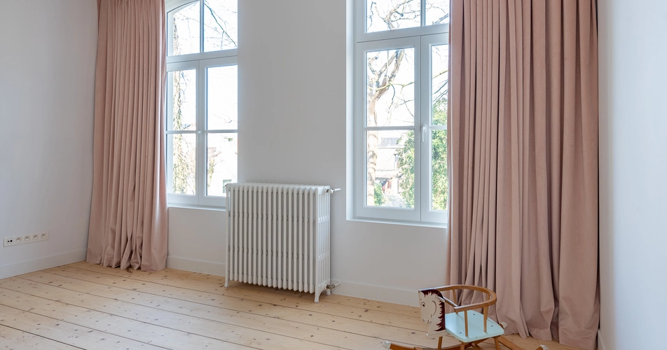 Roze velours schuifgordijnen in statige villa.